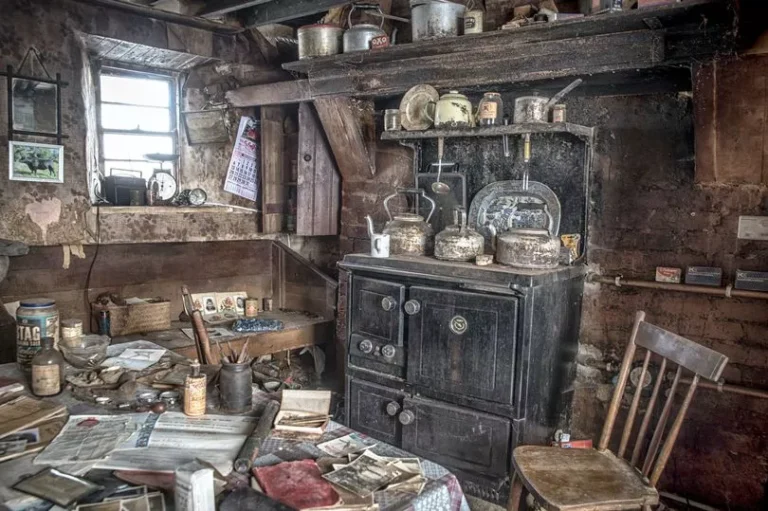 Creepy abandoned house with rotting clothes, stopped clock and Titanic paper clipping